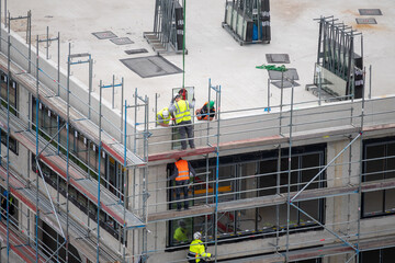 Glazier installing windows on a commercial building.