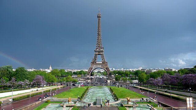 Eiffel Tower in Paris, France. World famous symbol of Paris with rainbow in background. Popular tourist destination. 