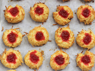 Homemade thumb print cookies filled with strawberry jam and grated cheese