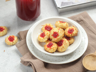 Homemade thumb print cookies filled with strawberry jam and grated cheese
