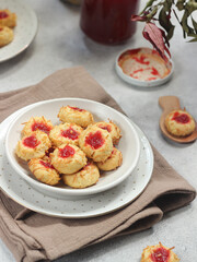 Homemade thumb print cookies filled with strawberry jam and grated cheese