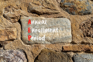 AEP symbol. Concept words AEP Annual enrollment period on beautiful big stone in stone wall....
