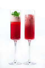 Pomegranate carbonated cocktail with mint in glasses on a white.