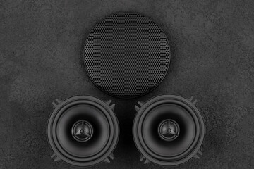 Stylish car audio acoustic round speakers and waffle grill protector cover on dark black background