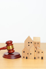 Real Estate Law, Home Insurance, property Tax, Auction and Bidding concepts. small toy house model...