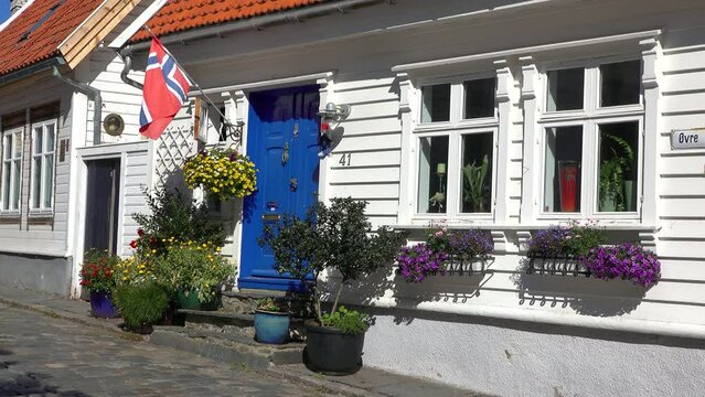 Establishing shot. Fragment of luxury house with flowers and nice facade in Stavanger, Norway.Typical Norwegian residential cottages