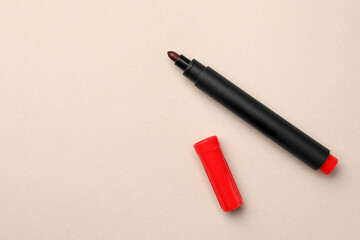 Bright red marker on beige background, flat lay. Space for text