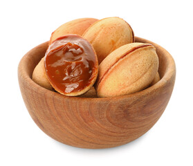 Delicious nut shaped cookies with boiled condensed milk in wooden bowl on white background