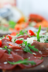 Prosciutto, parmesan, tomato and ruccola - italian antipasti.