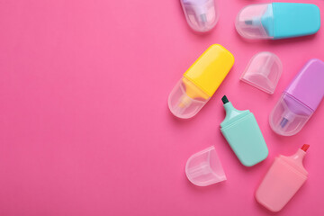 Many colorful markers on pink background, flat lay. Space for text