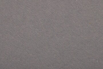 Fototapeta na wymiar Texture of grey paper sheet as background, top view