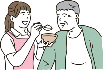 食事介助をする女性介護士と高齢者男性