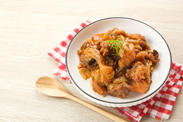 Ayam Goreng Mentega or Butter Chicken in white plate. Indonesian food.
