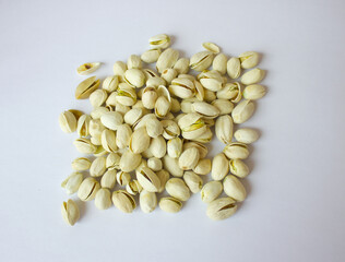 Pile of Pistachios isolated on white background. Pistachios closeup for your design and print. Nuts collection