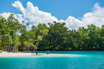 Tropical beach with small boat at Duke of York island, Papua New Guinea.