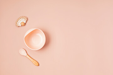 Top view of baby dishware. First safe plate and tableware for baby and toddler. Flat lay, mockup