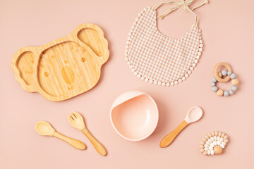 Top view of baby dishware. First safe plate and tableware for baby and toddler. Flat lay, mockup