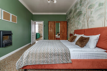 Bedroom in retro style with bed, old wardrobe and green walls