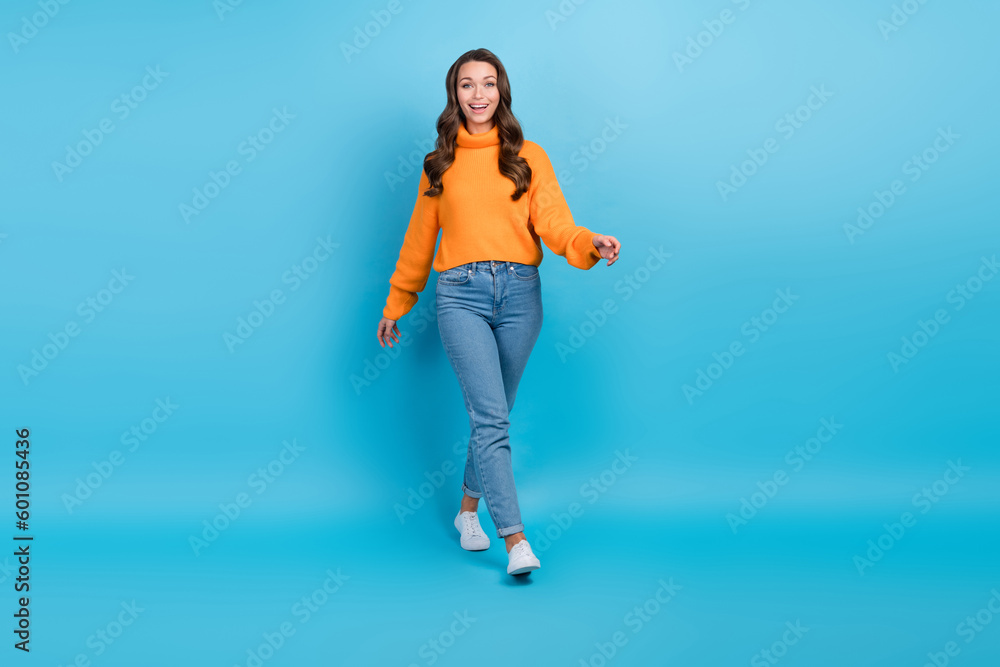 Sticker Full length photo of adorable excited lady dressed orange pullover walking smiling isolated blue color background