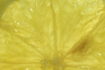 Macro closeup of bright yellow lemon pulp texture.