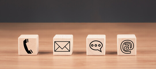 Contact us icon (email, call phone, address, Chat message icons) on wood cube, Website page contact...