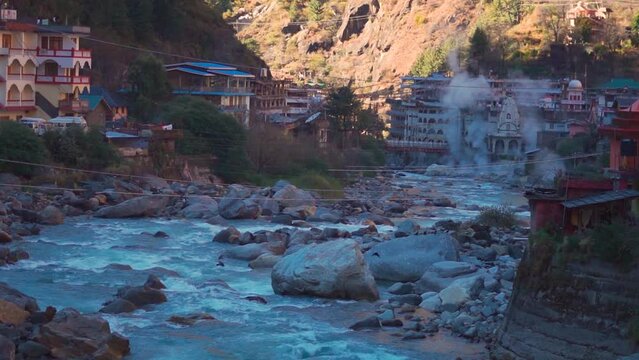 View of the Manikaran town with vapors arising from the hot water spring besides the river parvati at Manikaran near Kasol in Himachal Pradesh, India. Manikaran town besides the river Parvati in India