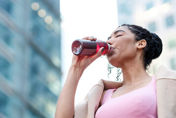 Portrait of young fitness woman drinking energy drink.