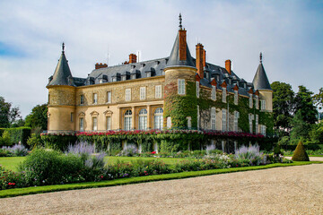 Castle of Rambouillet near Paris, Yvelines, France - Old stately home that was the official residence of the Presidents of the French Republic with round turrets covered with vines