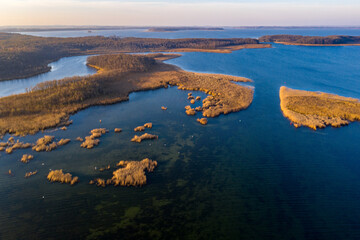 Masurian Lake District in Poland - beautifiul drone landscape, blue water, forest, autumn sunset time, Mazury great lakes
