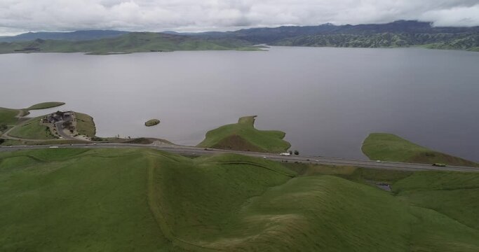 Highway and Lake. Upper Cottonwood Creek Wildlife Area with San Luis Reservoir in Background near Los Banos. California. Drone