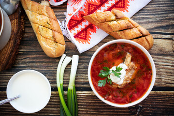 
Ukrainian borscht with sour cream. On a wooden background. Dinner