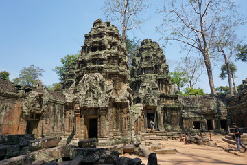 Ta Phrom temple with trees growing from the rocks (which inspired Tombraider, Lara Croft) - obrazy, fototapety, plakaty