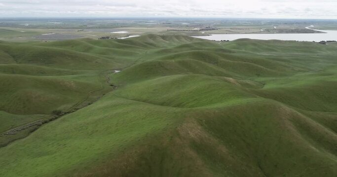 Upper Cottonwood Creek Wildlife Area with Lake of San Luis Reservoir in Background near Los Banos. California. Drone