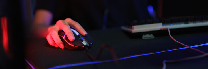 Hand of female cyber hacker gamer on mouse to playing games or hacking programming system