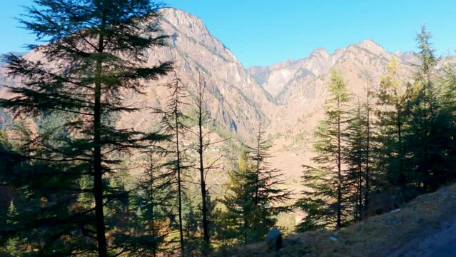 4K shot of Himalayan mountains as seen from the road towards Kasol in Himachal Pradesh, India. Beautiful mountains of Himachal. Scenic views of the drive in the Himalayan mountains. Nature background.
