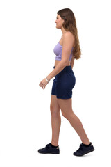 Fototapeta premium side view of a young girl walking on white background