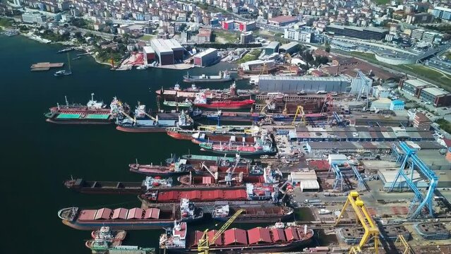 Shipbuilding and ship repair yard. Shipyard contains many cranes, dry docks, slipways, warehouses, painting facilities and large areas for fabrication of ships