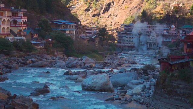 View of the Manikaran town with vapors arising from the hot water spring besides the river parvati at Manikaran near Kasol in Himachal Pradesh, India. Manikaran town besides the river Parvati in India