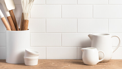Fototapeta na wymiar Stylish white kitchen background with kitchen utensils, copy space for text