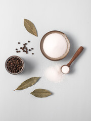 Salt, garlic, pepper, bay leaf. Light gray-blue background. Broth Ingredients.