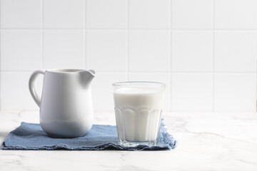 Obraz na płótnie Canvas Glass of milk on a light background. Stylish kitchen background.