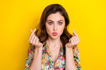 Portrait of stunning lady pouted lips kiss arms fingers demonstrate korean love gesture isolated on yellow color background