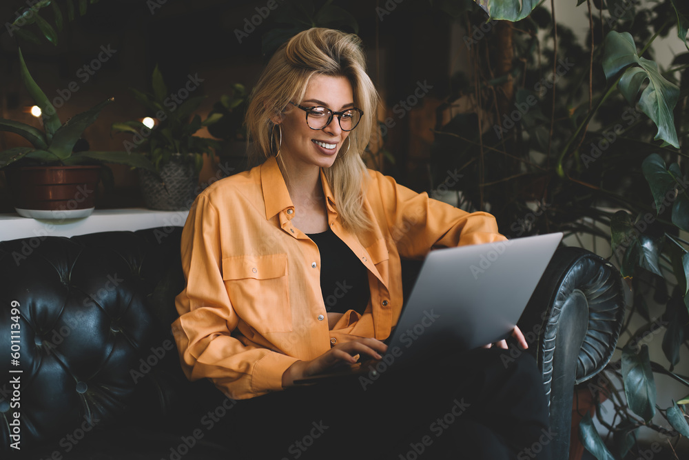 Poster happy freelancer in optical eyeglasses for vision correction watching browsed video on digital netbo