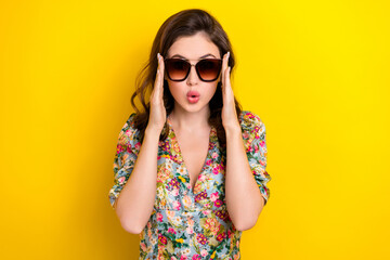 Photo of shiny impressed lady wear retro flower print blouse arms dark eyeglasses isolated yellow...