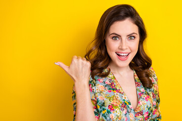 Portrait of positive nice person indicate thumb finger empty space isolated on yellow color background