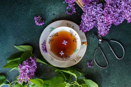 Top view of tasty black tea in vintage cup on mint green concrete table