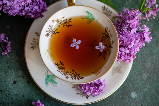 Top view of tasty black tea in vintage cup on mint green concrete table