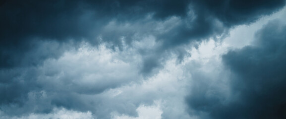 Dramatic cloudscape texture. Dark heavy thunderstorm clouds before rain. Overcast rainy bad weather. Storm warning. Natural blue background of cumulonimbus. Nature backdrop of stormy cloudy sky.