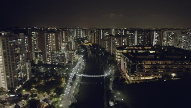 Night aerial drone view of HDB estates along riverside in Punggol - Singapore 2022