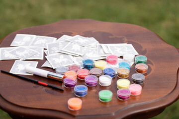 All the material ready on the table for making Shimmering sparkling glitter tattoo for children at...